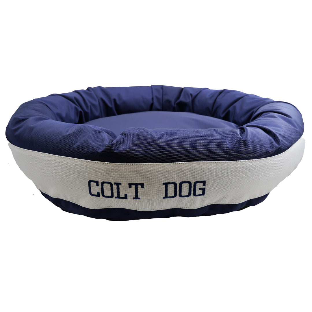 Round bolstered Dark blue and white dog bed with Colt Dog embroidered in dark blue