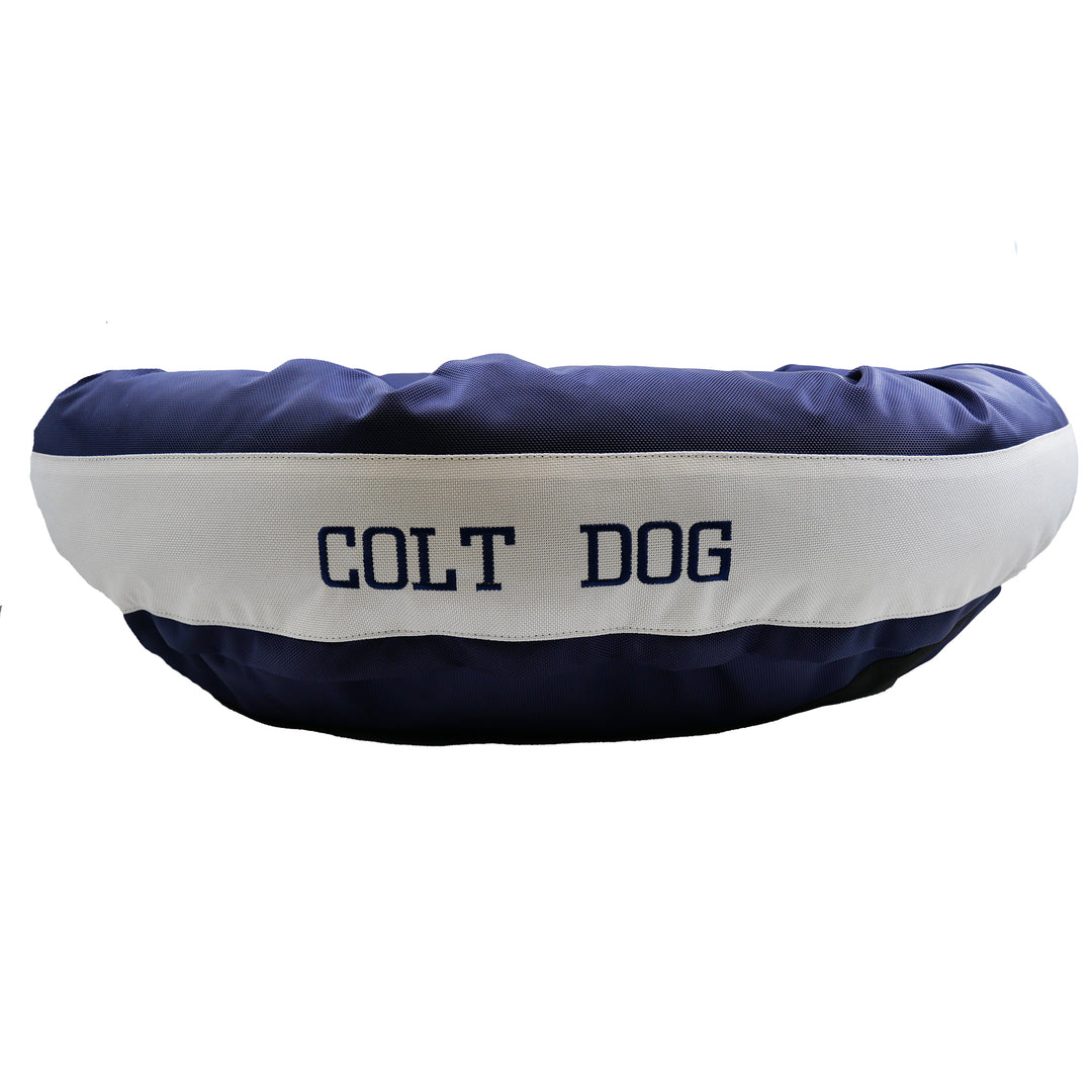 Dark blue and white dog bed with Colt Dog embroidered in dark blue
