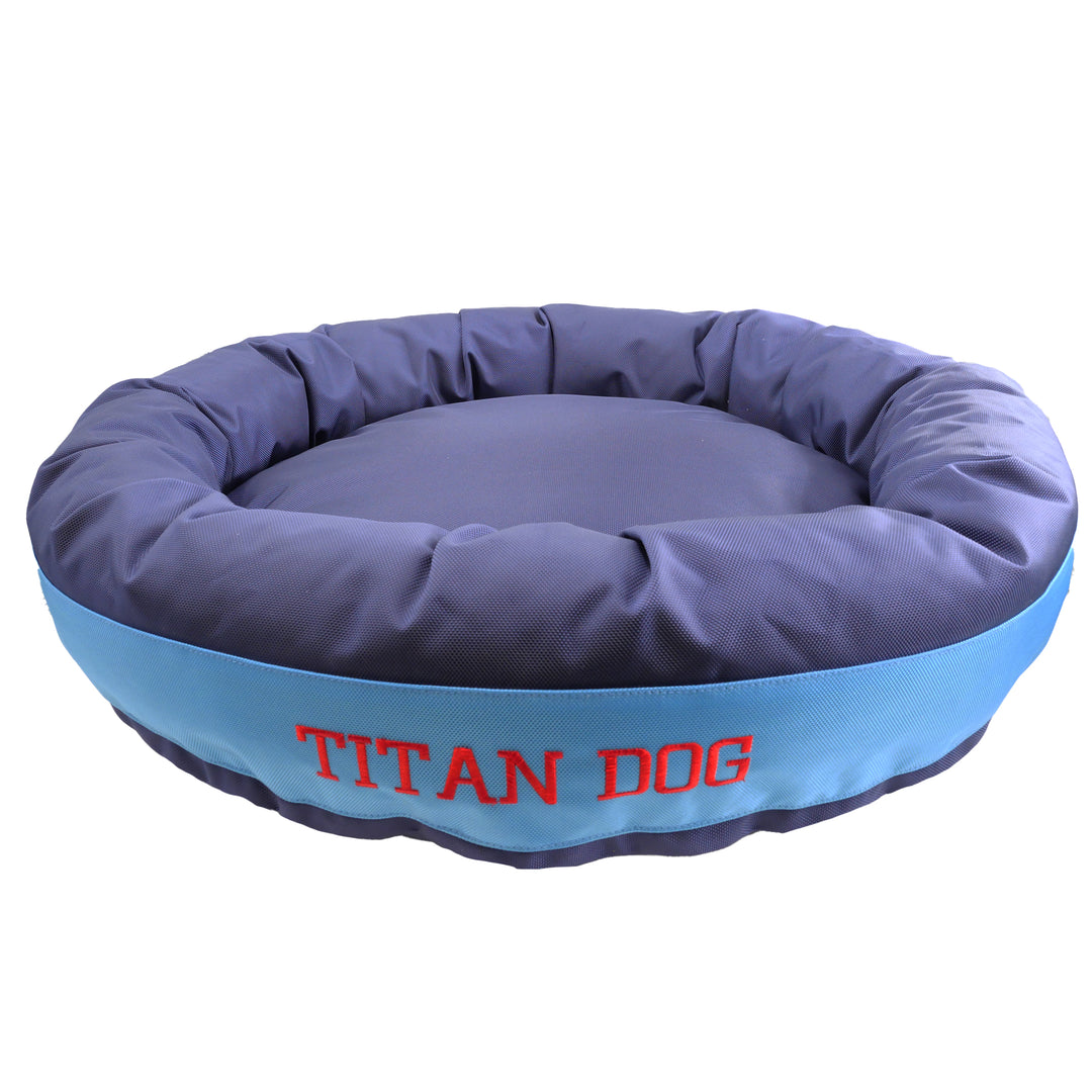 Blue and light blue round bolstered dog bed with Titan Dog embroidered in red