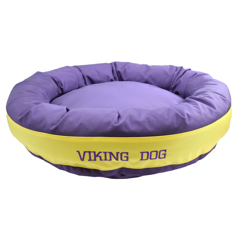 Purple round bolstered dog bed with yellow band and purple embroidered 'Viking Dog'.