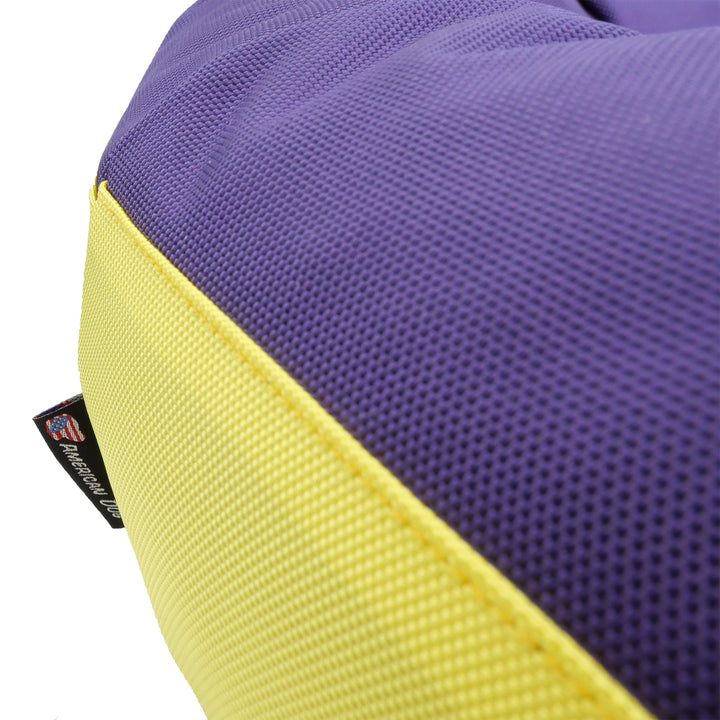 Close up of purple and yellow fabric with an American Dog label.