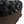 Round fuzzy black bolstered d bed close up showing textureg lower fabric
