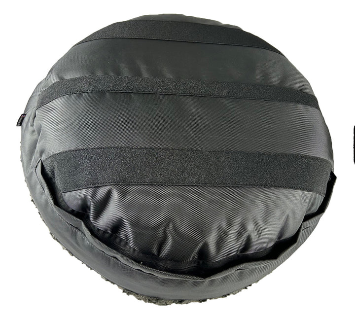 Round fuzzy charcoal bolster bed back side showing grip strips
