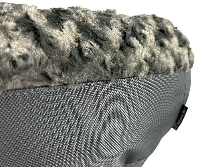 Round fuzzy charcoal bolster bed close up showing texture